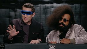Poster for Reggie Watts Wears a Purple and Yellow Quilted Sweatshirt